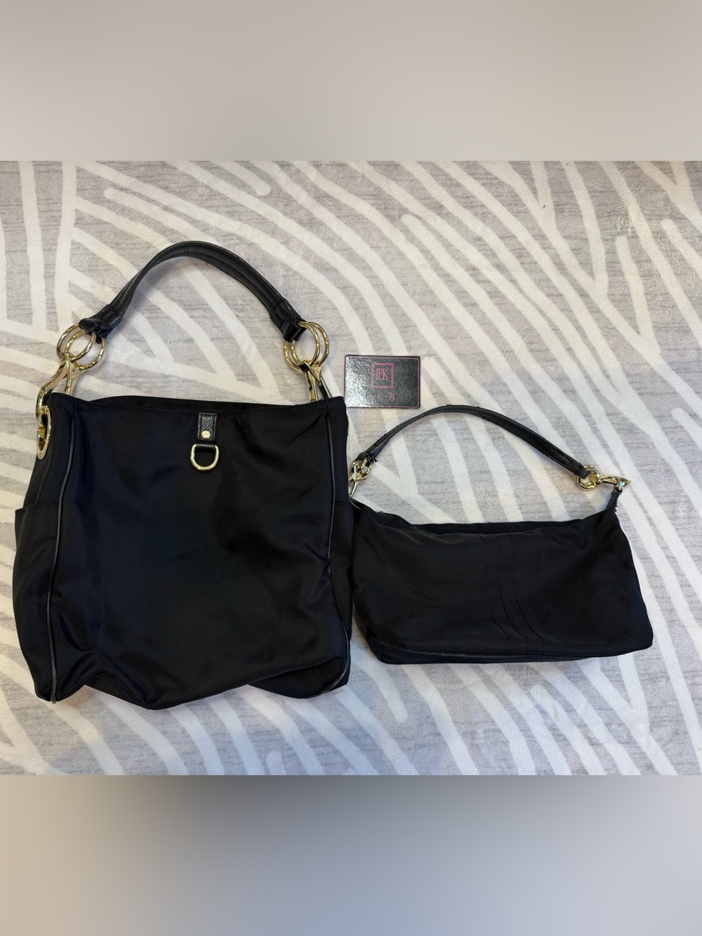 Two JPK Paris 75 black ballistic purses - bucket and handbag purse